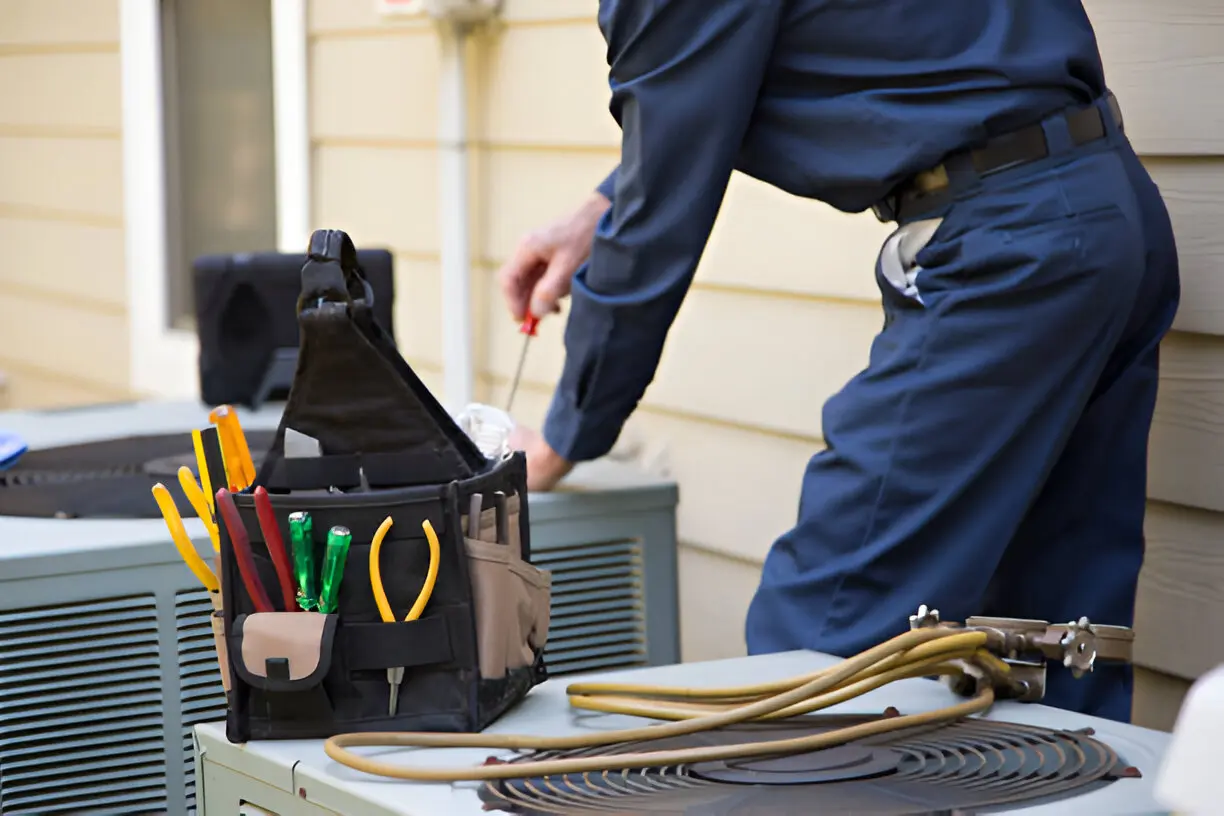 Home 12 HVAC expert fixing a malfunctioning air conditioning unit in Orlando